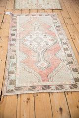 Stepped geometric medallion, finned floral blossoms, heavy abrashes on vintage Oushak rug.
