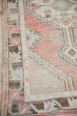 Vintage distressed Oushak rug's textured pile and geometric border in dusty blush, slate, charcoal.