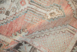 Distressed vintage Oushak rug pile showing even wear, dusty blush, ivory, and slate blue hues.