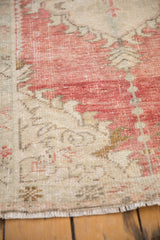 Evenly worn knot heads and time-softened colors on a distressed Oushak rug corner.