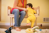 A mother and baby interact with the sturdy, handcrafted white maple sidecar bench.