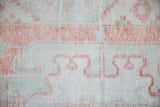 Faded terracotta, dusty mint green distressed Oushak rug pile detail.