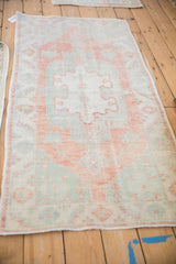 Distressed Oushak runner, faded abrashed field in terracotta, dusty mint green, and ivory.