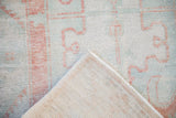 Distressed Oushak runner pile in terracotta and mint green with woven foundation.