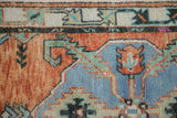 Vintage Oushak rug detail: low pile, rust, faded blue, ivory, and charcoal serrated vines.