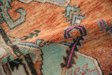 Vintage Oushak rug close-up showing low shorn pile, serpent border in rust, faded turquoise, and magenta.