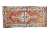 Vintage Turkish Oushak runner with a stepped geometric medallion in rust, turquoise, saffron yellow, and blue.
