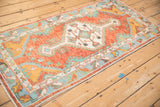 High-angle view of the vintage Oushak rug runner, showing the low pile and full geometric medallion pattern.