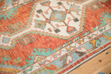Angled view of the Oushak's stepped medallion, showing heavy rust abrashes and turquoise accents.