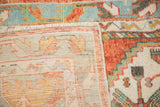 A vintage Oushak runner with a corner folded back to reveal its hand-knotted foundation.