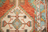 Close view of the vintage Oushak's even, hand-knotted pile and geometric stepped design.