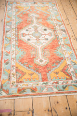 Vintage Oushak runner with a stepped geometric medallion, viewed from a high, angled perspective.