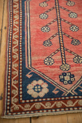 Vintage Oushak rug corner detail: blush tree of life motif, dark blue, vine border.