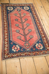 Angled view of blush Oushak rug showcasing germinating tree motif and vine border.