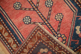 Blush Oushak rug with tree of life blossoms, revealing intricate hand-knotted back weave.