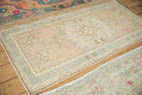 Distressed vintage Oushak runner detail with even wear, dusty rose, and faint blue hues.