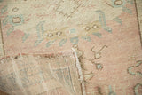 Vintage distressed Oushak rug runner, showing muted dusty rose pile with woven foundation.