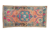 Vintage distressed Oushak rug with a central teal medallion and fuchsia accents over an abrashed cantaloupe field.