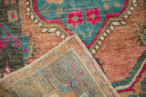 The reverse view of a vintage Oushak rug showing its hand-knotted foundation and secure side cord.