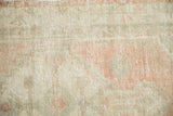 Even wear to the knot heads showing the distressed texture and faint foundation of the rug.