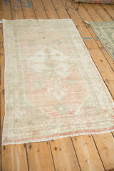 Angled view of a distressed Oushak rug highlighting its even wear and soft, tone-on-tone palette.