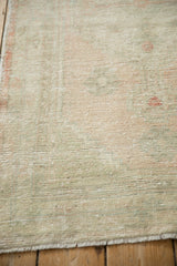 Detailed texture of a distressed Oushak rug with even wear to the knot heads.