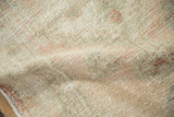 Even wear on the low pile of a distressed Oushak rug showing the hand-knotted foundation.