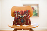 Red Persian Rug Pillow with early 20th century hand-knotted patterns in red, blue, and tan.