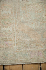 Texture of a distressed vintage Oushak rug with pile worn evenly to the knot heads.