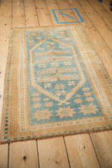 Angled perspective showing the full length of a distressed Oushak rug.