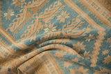Softly draped vintage Oushak rug showing its even pile in dusty blue and gold.