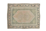 Distressed Oushak rug with a pale pink double medallion, olive green field, and vine border. 2'3
