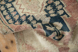 Textured pile of vintage distressed Oushak rug runner with muted coral and abrash blue.