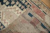 Distressed dark blue geometric pattern and beige pile, showing hand-knotted Oushak rug foundation.