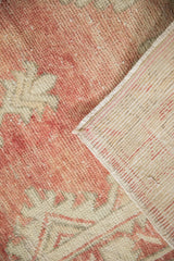 Evenly worn pile of vintage Oushak rug in dusty brick red and antique ivory, revealing woven foundation.