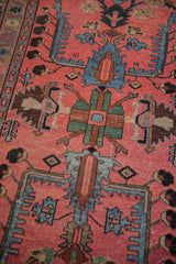 Pale raspberry field, mallard green palmettes and sapphire blue geometric patterns.
