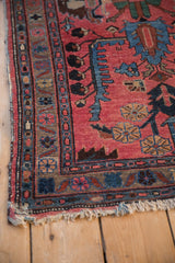 Vintage Mehreban rug: tattered end, raspberry red field, natural ground border.