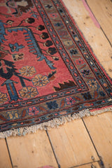 Vintage Mehreban rug corner, showing tattered fringe and main border in natural, raspberry, sapphire blue.