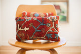 Vintage hand-knotted Persian rug pillow in rich red, blue, and ivory curvilinear pattern, 8x14.