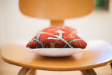 Vintage Persian rug pillow side profile showing red hand-knotted pile and white suede backing.