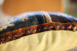Detail of antique Turkish rug pillow, rich patterned fragment, and ribbed lime green corduroy.