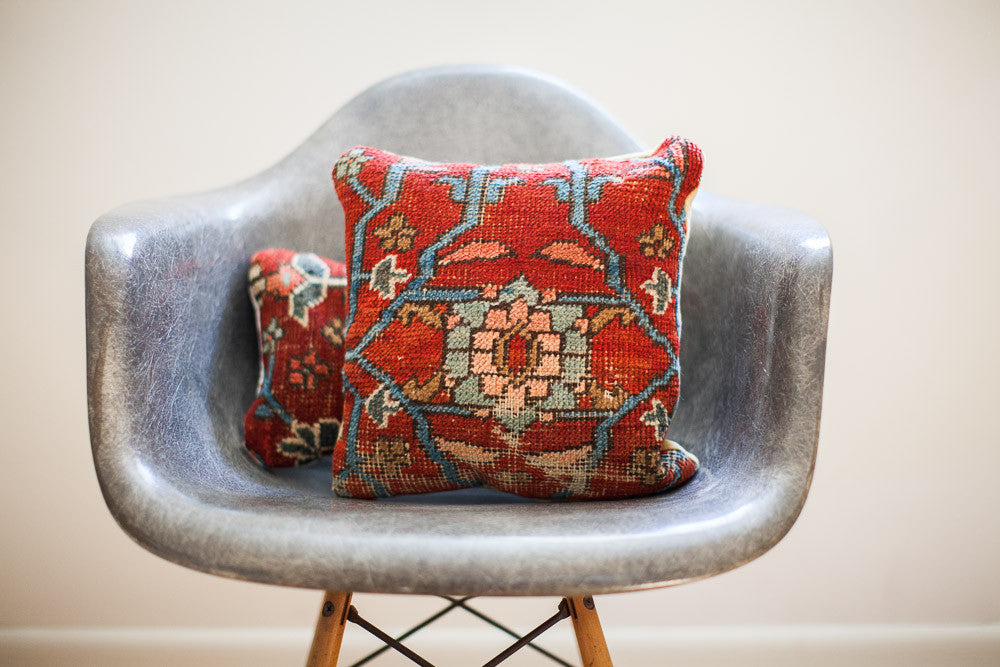 Early 20th century Persian rug pillow, red field with intricate blue and coral medallion.