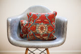 Early 20th century Persian rug pillow, red field with intricate blue and coral medallion.
