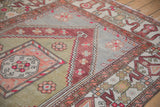 Detail of the geometric cloudband border and stepped medallion on a distressed Oushak rug.