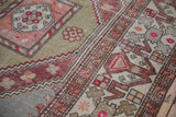 Expressive cloudband border in copper tones alongside the sage green field with distressed texture.