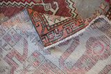 Hand-knotted foundation and secured machine-bound side of a distressed vintage Turkish Oushak carpet.