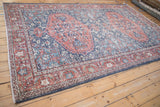 Distressed Sparta carpet corner with machine-bound fringe and terracotta floral border.