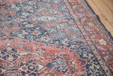 Distressed vintage Sparta carpet pile, showcasing worn floral patterns in navy and terra cotta.