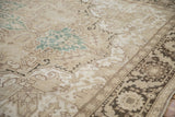 Distressed vintage Turkish Heriz rug with geometric palmettes, arabesques, and dusty teal accents.