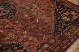 Vintage Qashqai carpet's dark navy blue geometric border contrasting with its patterned rust field.